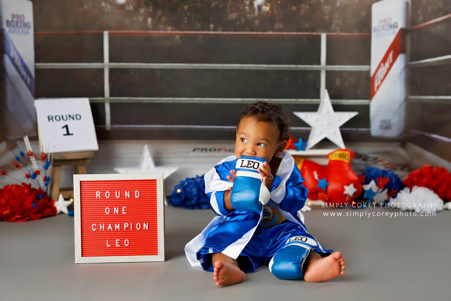 baby photographer near Carrollton, GA; one year old with boxing gloves