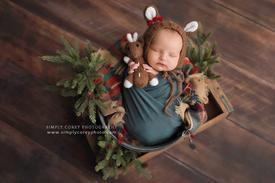 newborn photographer near Carrollton, Georgia; baby in reindeer hat and Christmas set