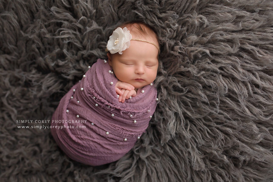 newborn photographer near Peachtree City; baby girl in purple wrap with pearls