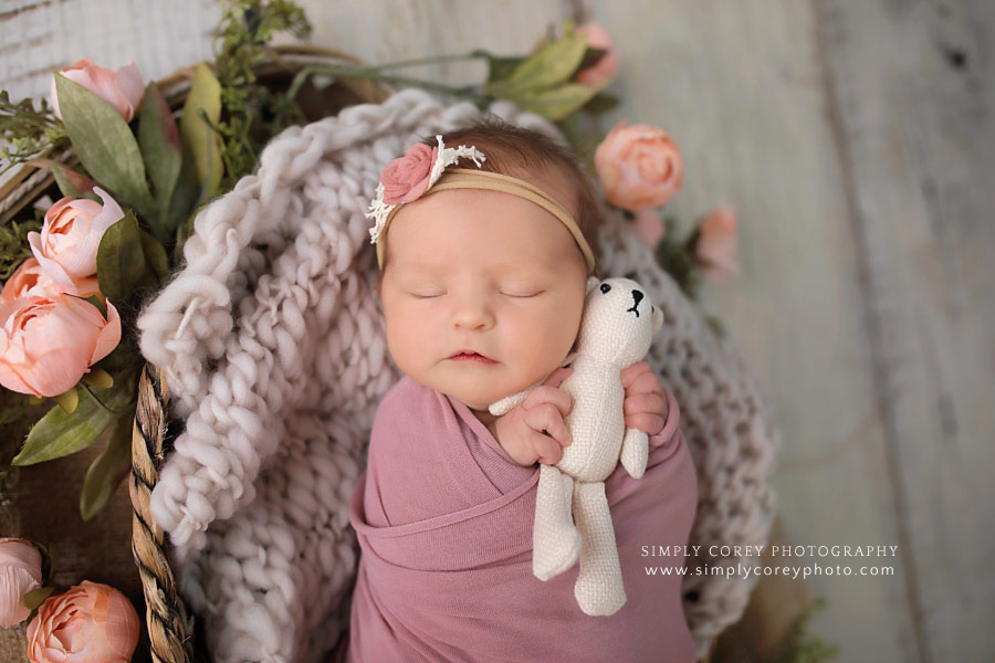 Peachtree City newborn photographer, baby girl in pink holding a teddy bear
