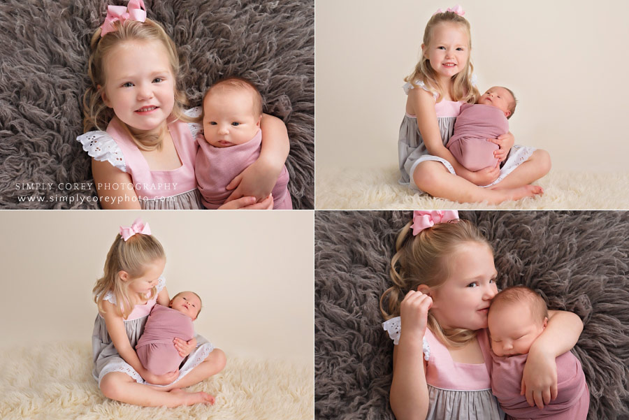 West Georgia newborn photographer, 3 year old holding baby sister
