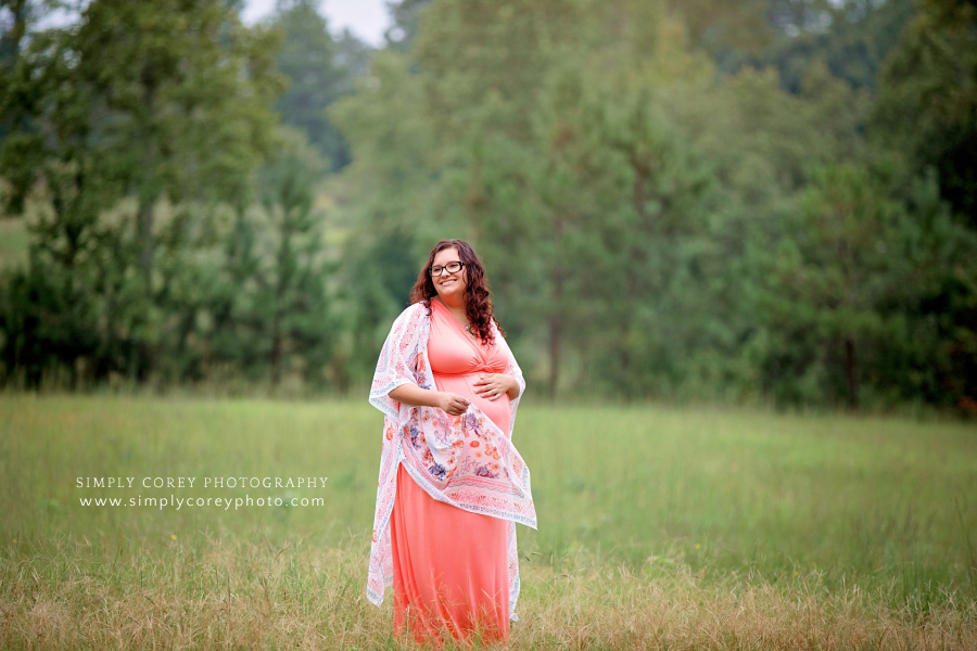 Atlanta maternity photographer, mom in coral dress and kimono outside in field