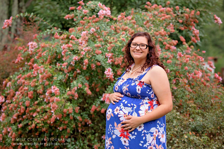 West Georgia maternity photographer, expecting mom in floral sundress outside