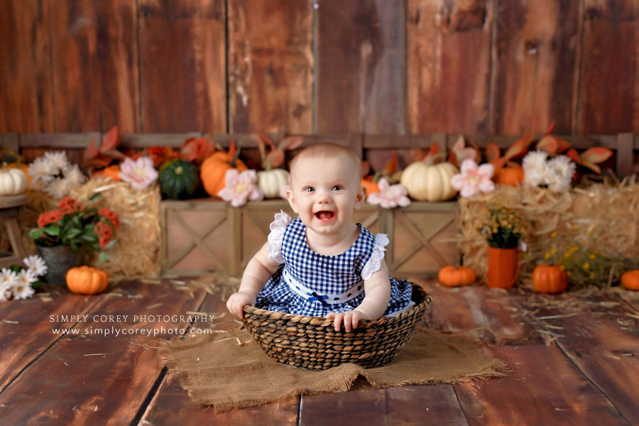 baby photographer near Atlanta, girl in basket for fall studio milestone session