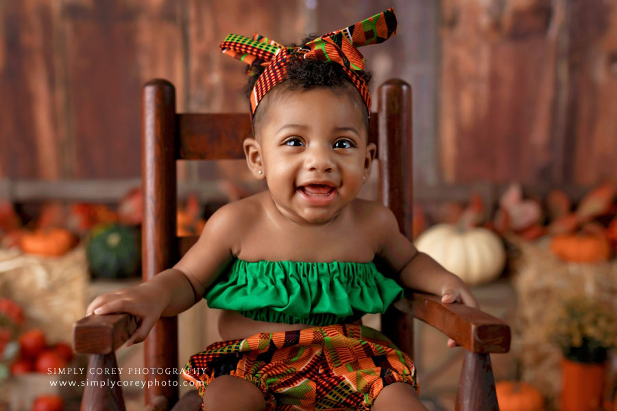 Newnan baby photographer, smiling girl during fall milestone session in studio
