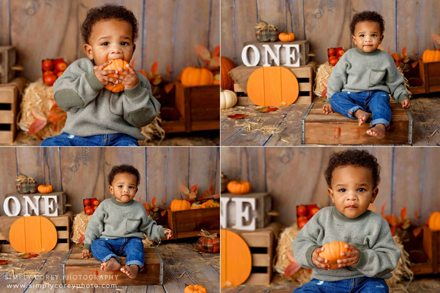 Carrollton Georgia baby photographer, toddler with pumpkin during one year session