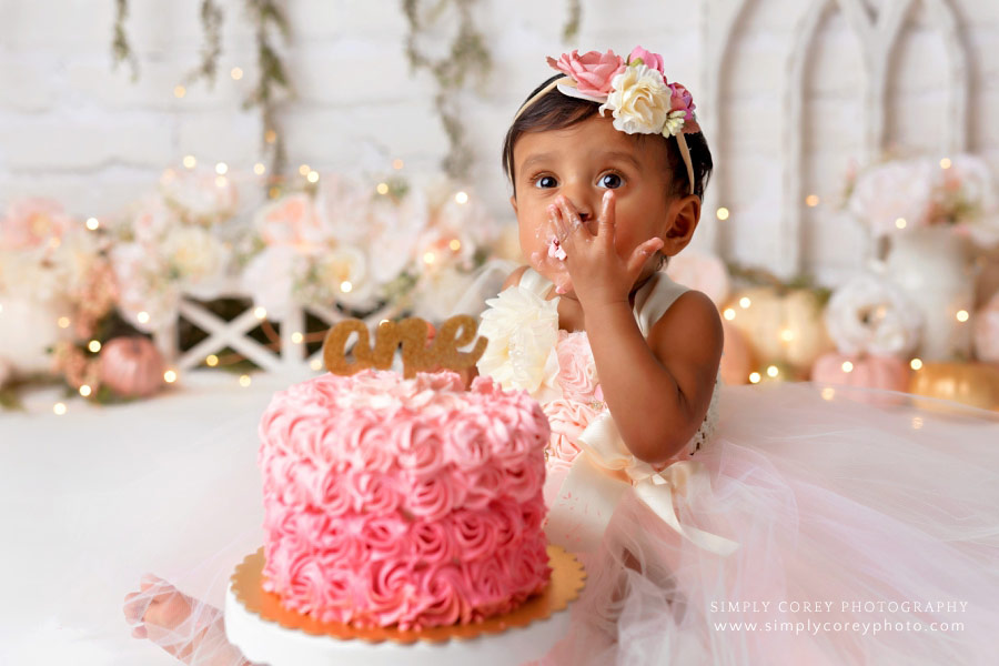 Atlanta cake smash photographer, baby girl eating pink ombre cake in studio