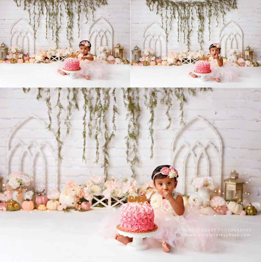 cake smash photographer near Hiram, baby girl with pink cake and pumpkins in studio