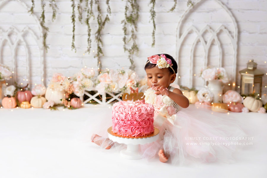 cake smash photographer near Villa Rica, baby girl with pink pumpkins and ombre cake