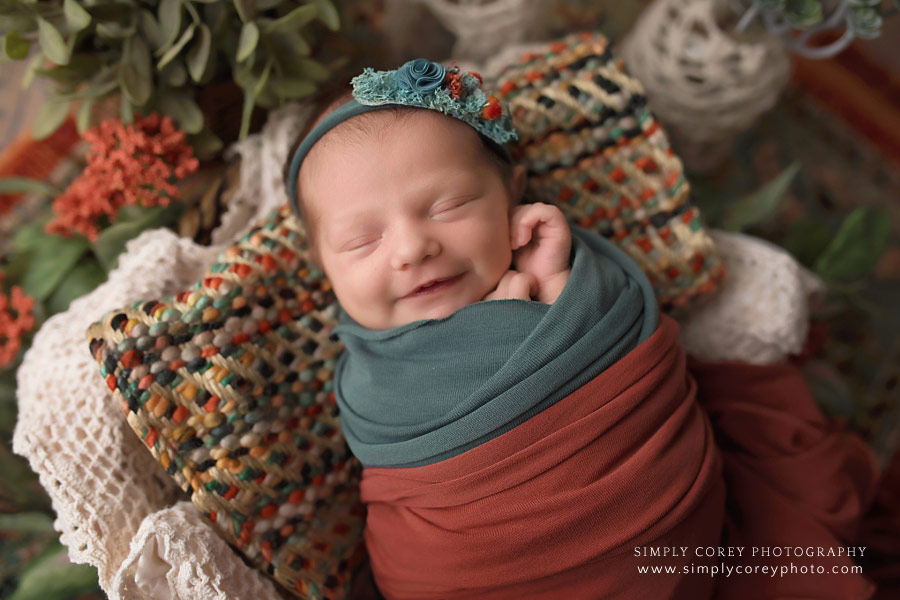 newborn photographer near Newnan, smiling baby girl in teal and orange boho set