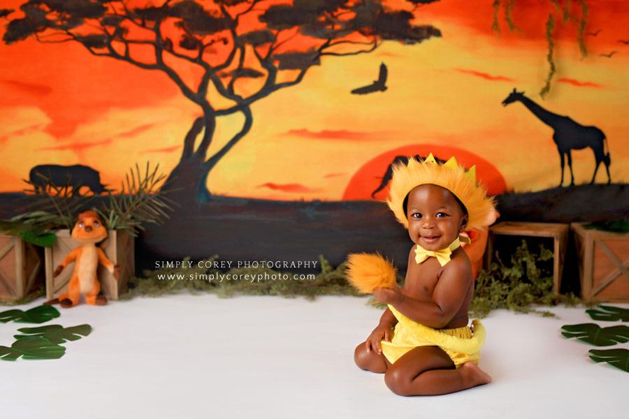 Douglasville baby photographer, boy playing with lion tail on costume