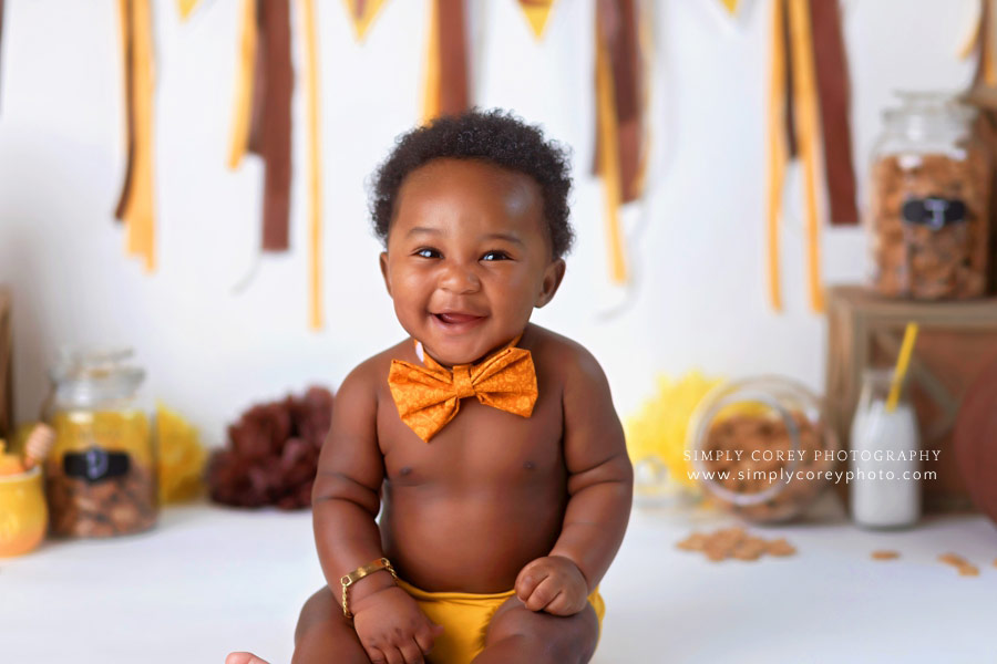 baby photographer near Carrollton, GA; 6 month baby boy smiling in a bowtie
