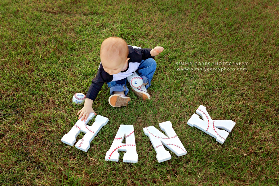Newnan baby photographer, boy on baseball field with letters for his name