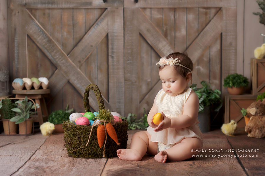 baby photographer near Villa Rica, girl with Easter basket and eggs in studio