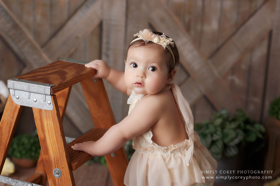 Villa Rica baby photographer, studio milestone session with girl and ladder