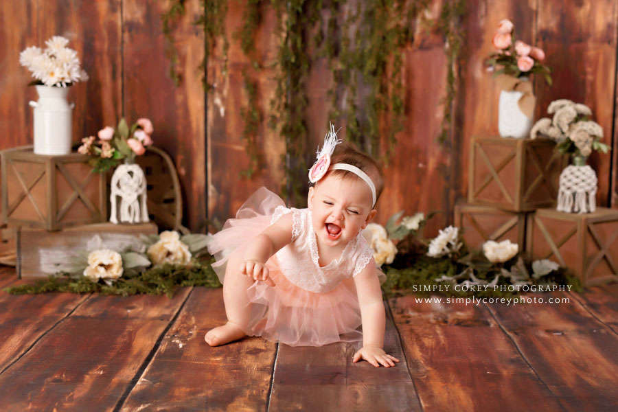baby photographer near Dallas, GA; girl laughing during rustic floral session