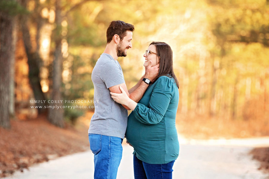 maternity photographer near Newnan, couple outside on country road in February