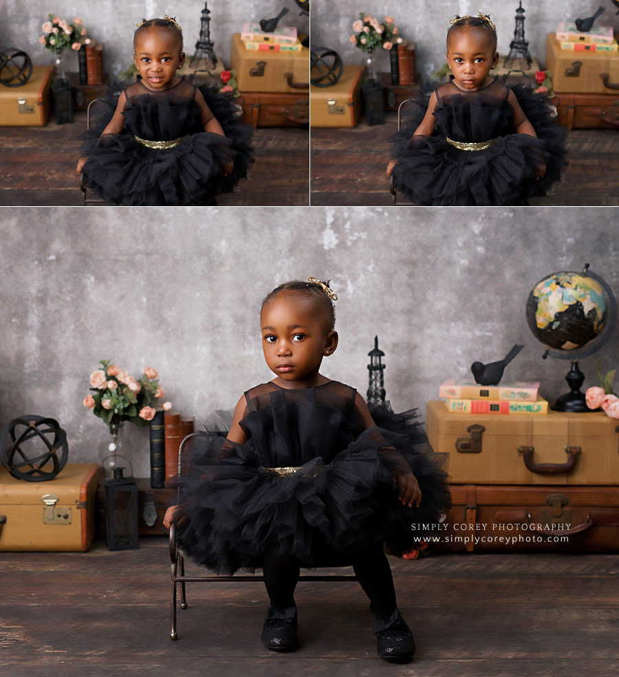 baby photographer near Dallas, GA; toddler in black tutu dress on vintage set
