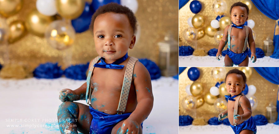 cake smash photographer near Atlanta, baby in suspenders with blue and gold prince theme