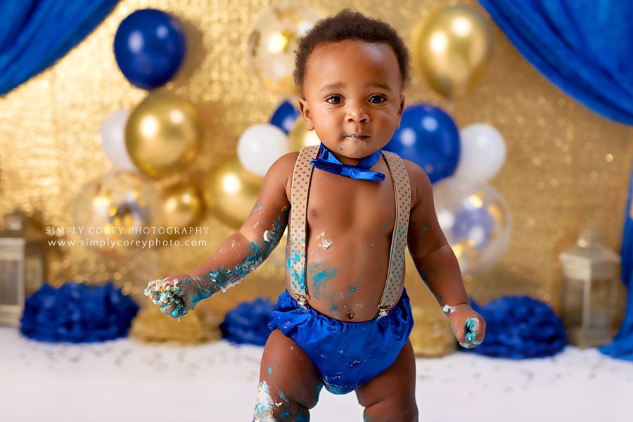 cake smash photographer near Newnan, baby covered in frosting with prince theme