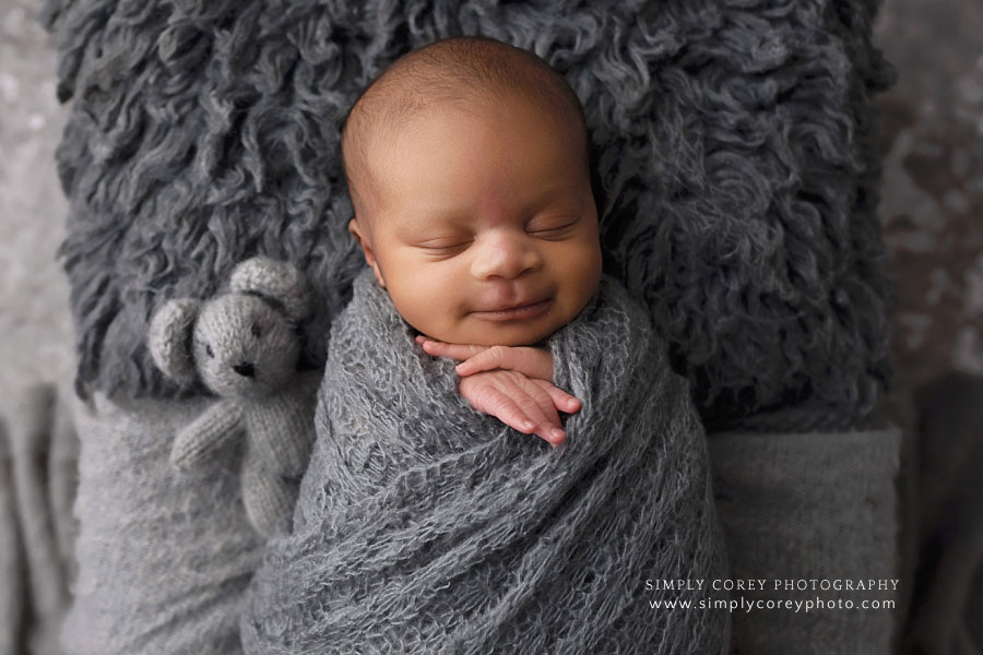 Carrollton newborn photographer in Georgia, smiling baby boy in gray
