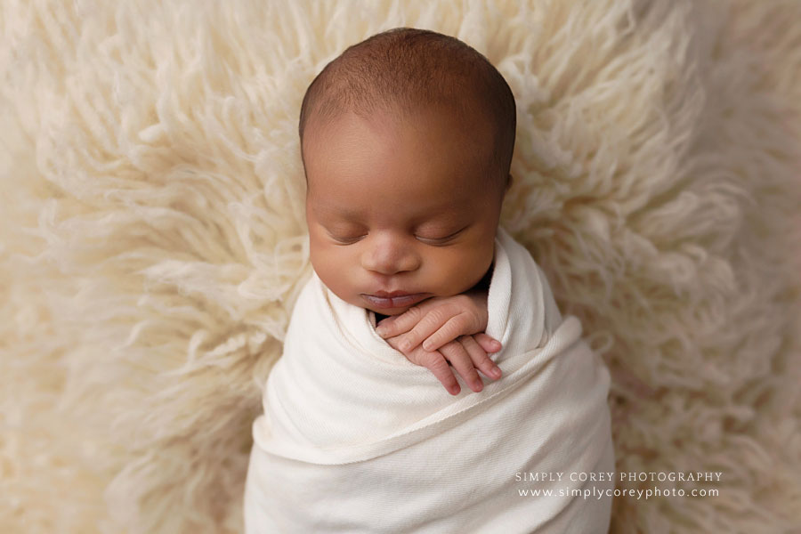Newnan newborn photographer, baby boy in cream wrap and fur