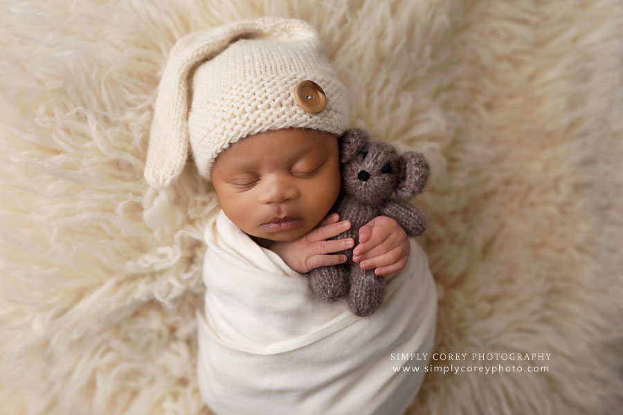 Villa Rica newborn photographer, baby boy holding a teddy bear