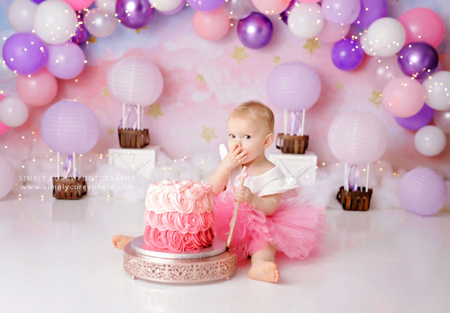 Newnan cake smash photographer, baby eating frosting from pink ombre cake