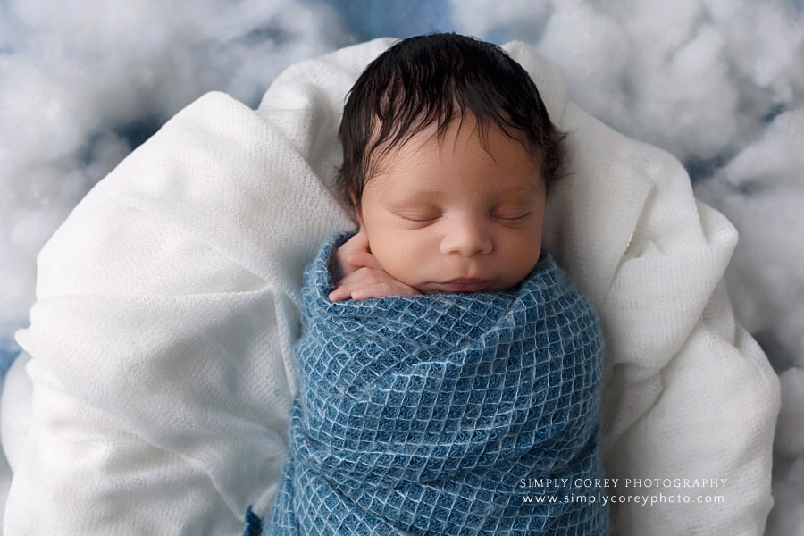 Douglasville newborn photographer, baby boy swaddled in blue