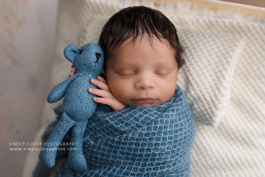 newborn photographer near Carrollton, Georgia; baby boy in blue with teddy bear