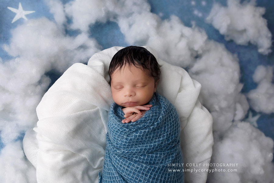 newborn photographer near Dallas, Georgia; baby in blue with stars and clouds