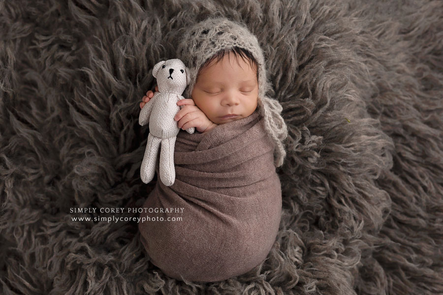 newborn photographer near Newnan, baby boy in brown holding a teddy bear