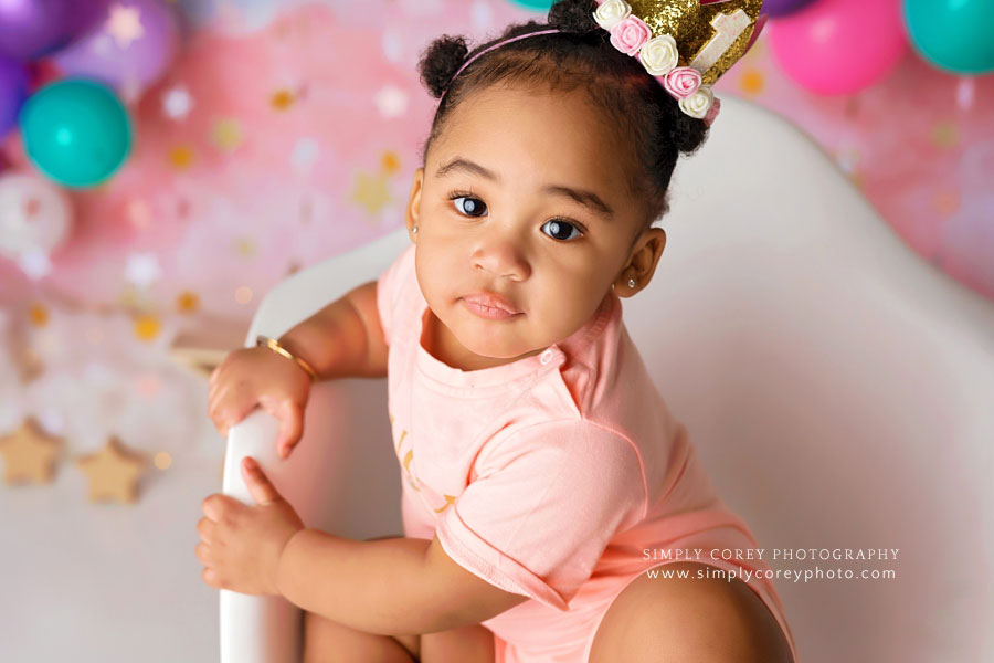 baby photographer near Carrollton, GA; closeup of girl in pink and one year crown