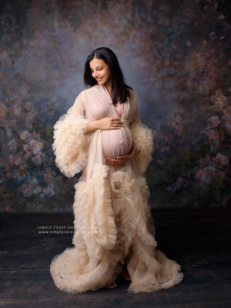 Newnan maternity photographer, studio portrait with floral backdrop and tulle robe