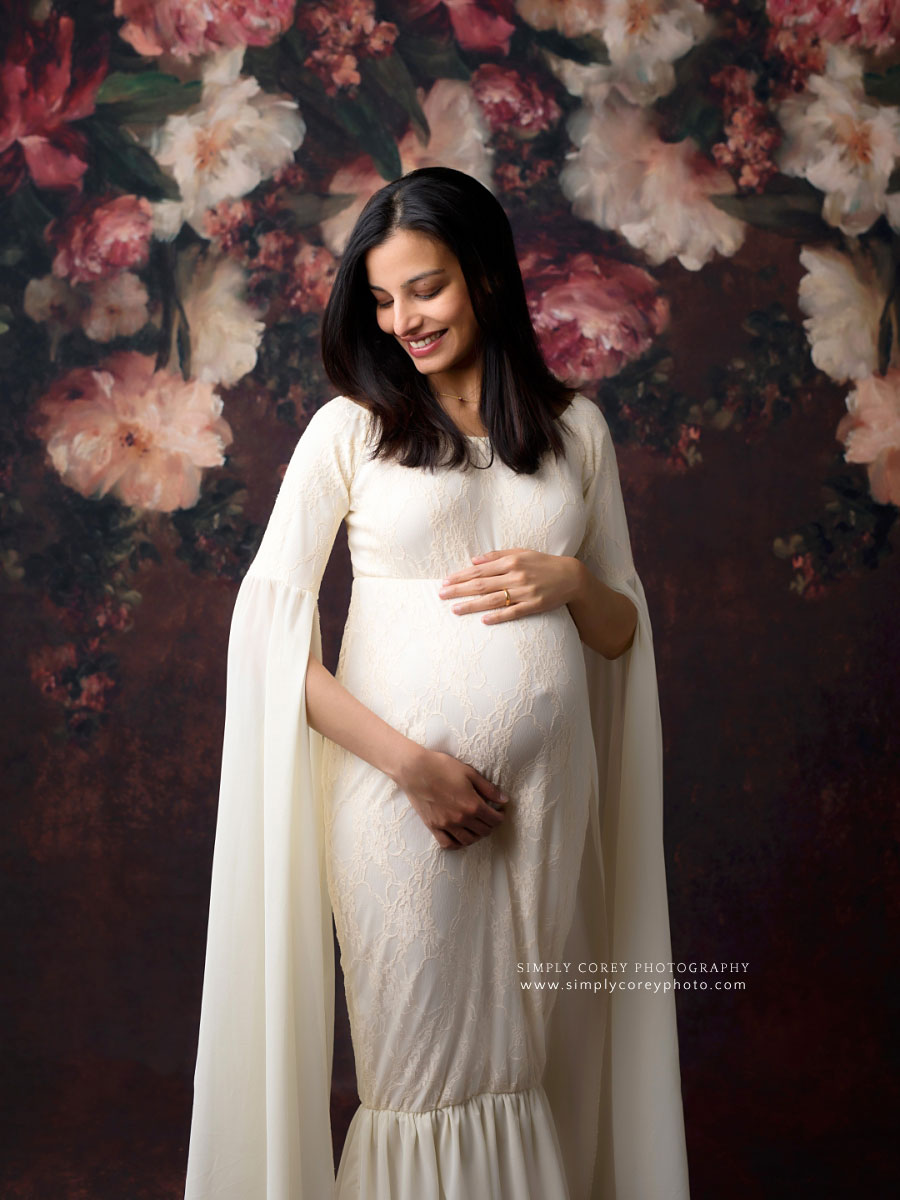 Newnan maternity photographer, studio session with white dress and floral backdrop