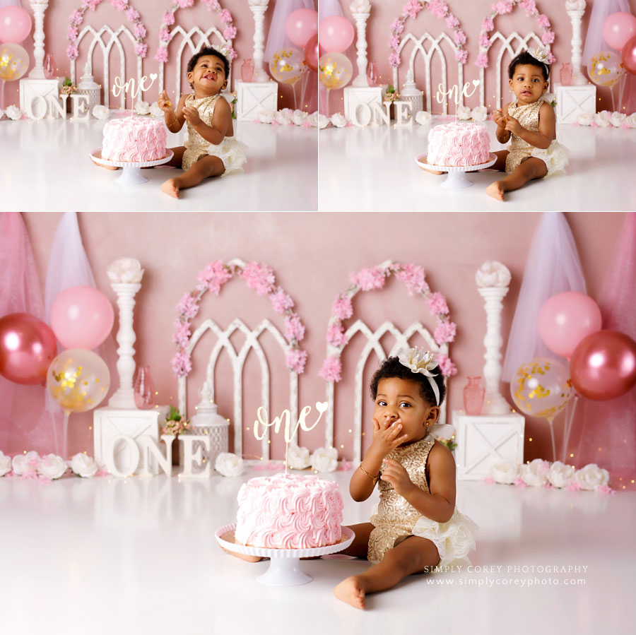 cake smash photographer near Peachtree City, baby girl in gold romper on pink studio set with balloons