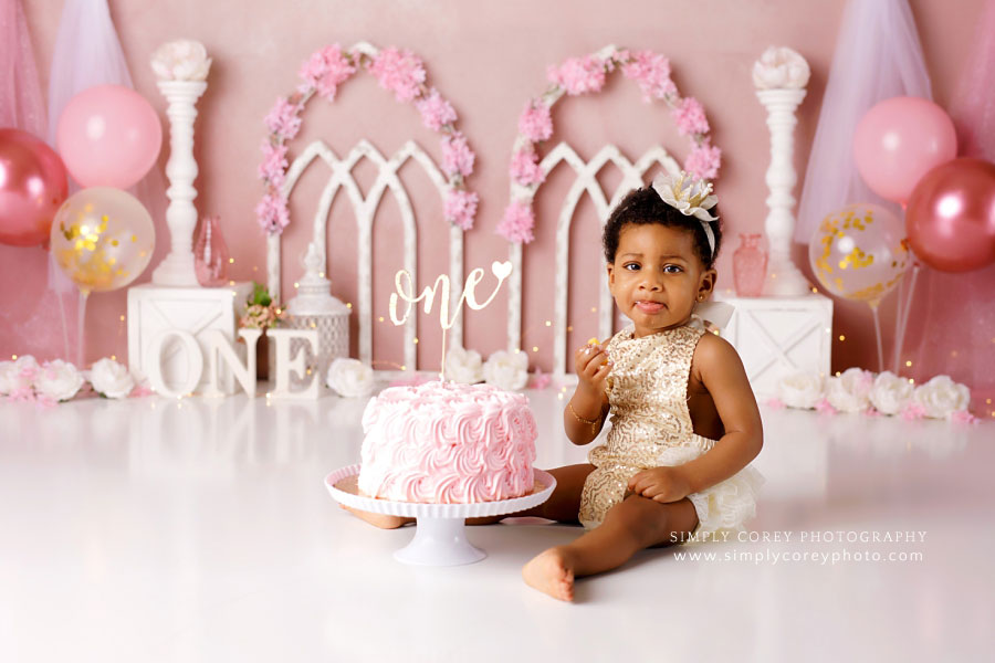Carrollton cake smash photographer in GA; pink white and gold studio set with balloons
