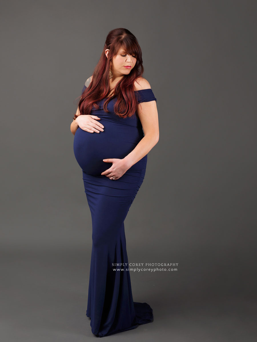 Hiram maternity photographer, mom in blue dress with gray studio backdrop