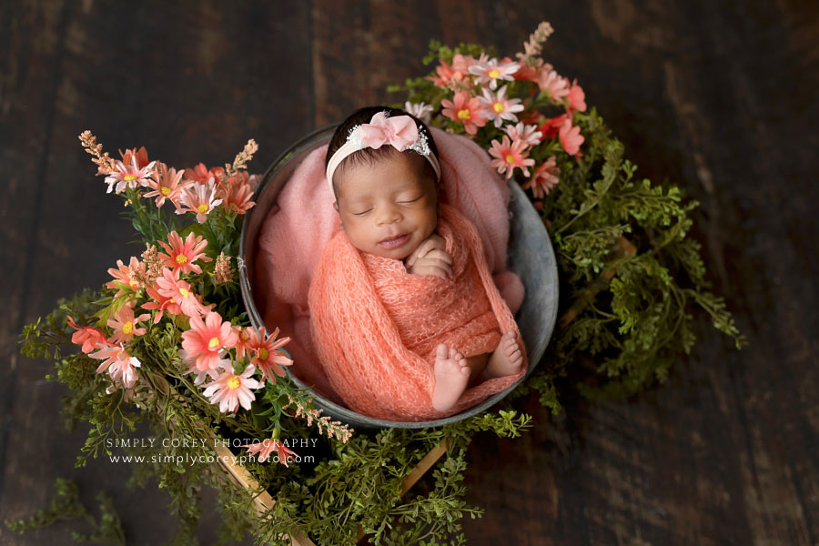 Villa Rica newborn photographer, baby girl in studio with coral wrap and flowers