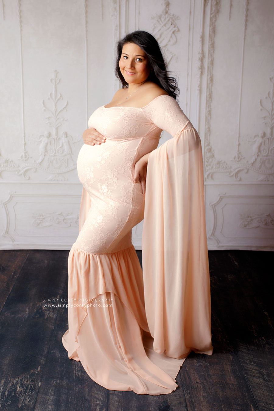 maternity photographer near Carrollton, GA; pregnant mom in a pink dress for a studio session
