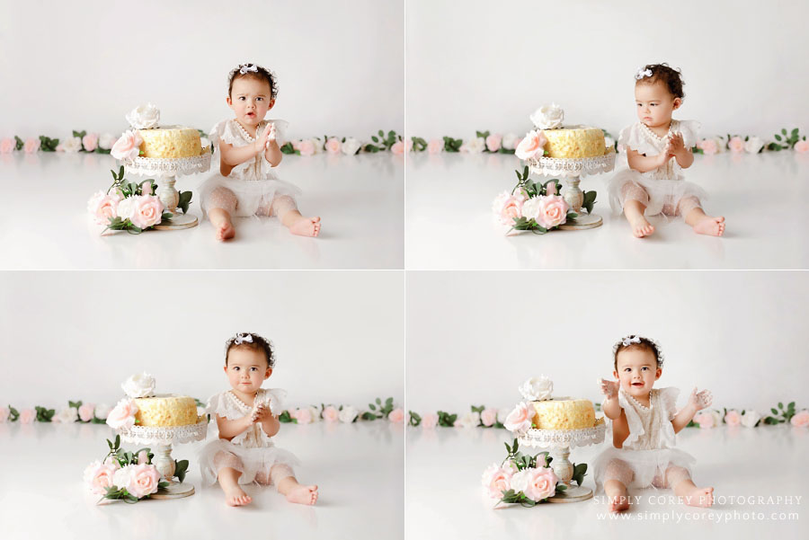 Douglasville cake smash photographer, baby on white floral set unsure of cake