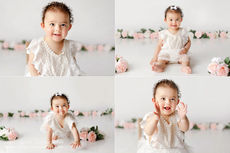 Peachtree City baby photographer, girl with white studio set and flowers for cake smash