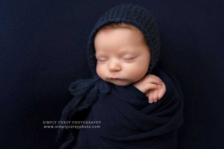 newborn photographer near Atlanta, baby boy in navy blue studio set