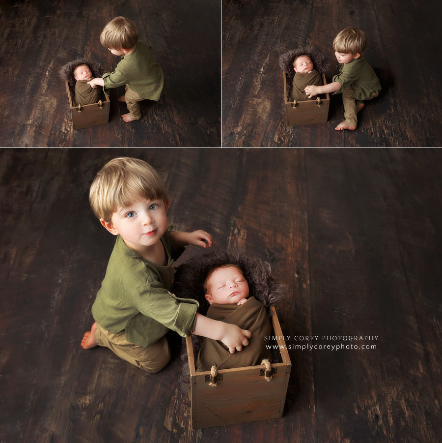 newborn photographer near Dallas, GA; toddler big brother with new baby in studio