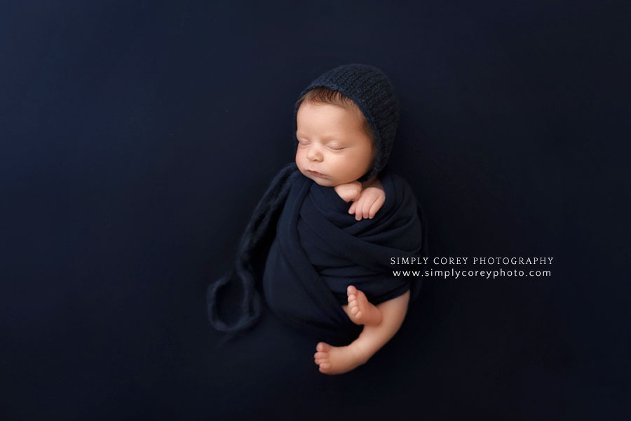 newborn photographer near Villa Rica, baby boy in navy blue set in studio