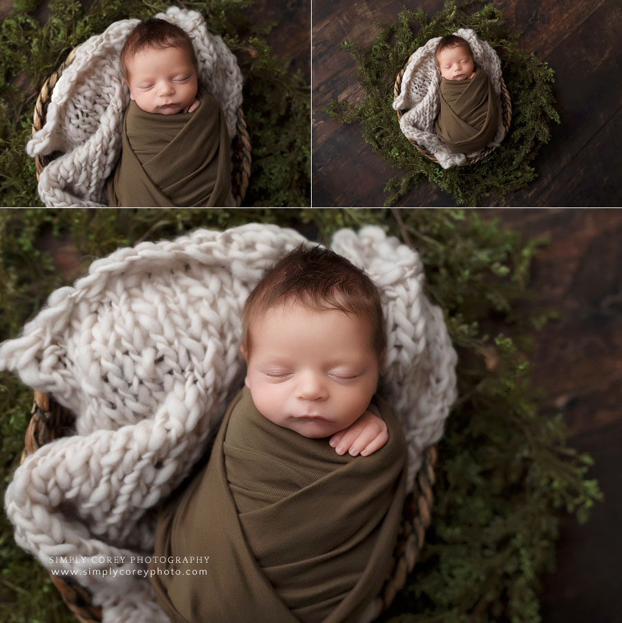 newborn photographer near Fayetteville, GA; baby boy in green swaddle with greenery