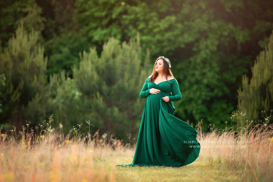 maternity photographer Newnan, outdoor session in green dress near pine trees