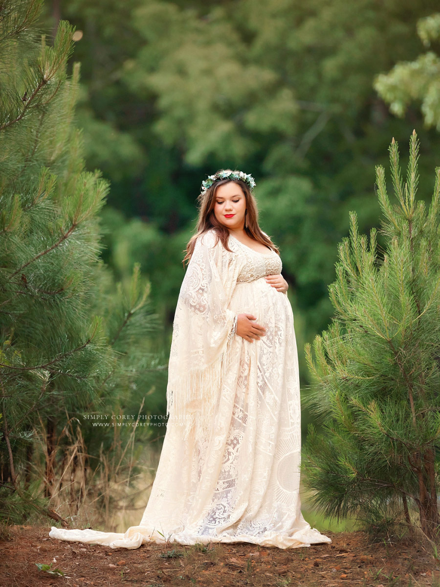 maternity photographer near Villa Rica, mom in lace boho dress outside near pine trees