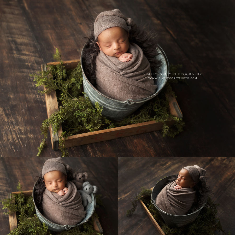 newborn photographer near Dallas, GA; baby boy in brown with greenery and bucket