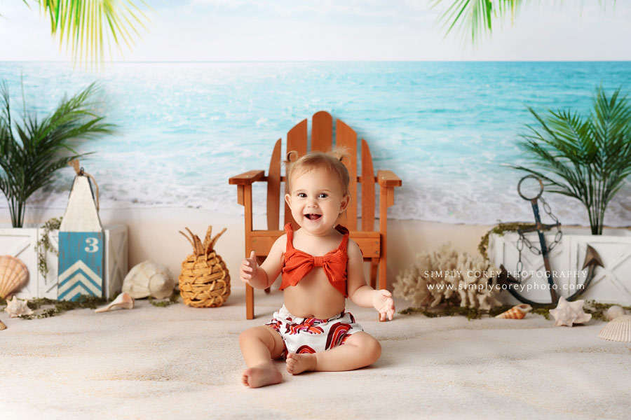 Newnan baby photographer, girl laughing in boho rainbow bathing suit for beach milestone session